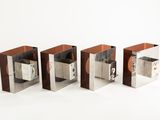 three silver and wood bookends sitting side by side on a white surface