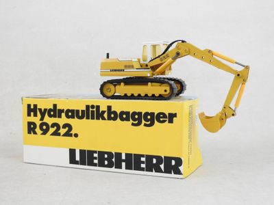 a yellow toy bulldozer sitting on top of a box