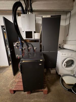 an image of a dirty laundry room with a washing machine and dryer