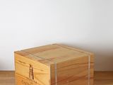 a wooden box sitting on a table next to a plant