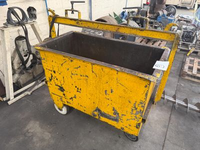 a yellow box with a black top sitting in a garage
