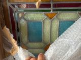 a man that is putting a piece of glass in a window
