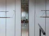a room with a lot of closets and a mirror