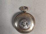 a silver pocket watch with a picture of a woman on it