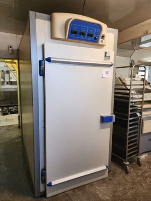 an image of a refrigerator in a kitchen with the door open