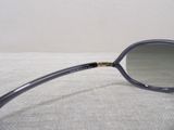 sunglasses on a bed with a white wall in the background