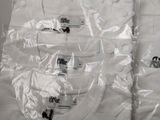 two shirts wrapped in plastic and one has a logo on it