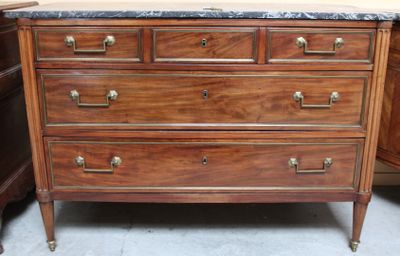 a wooden dresser with marble top in a room