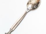 silver spoon on a white surface with a silver handle