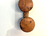 a wooden object on the wall with a shadow on it