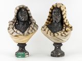 pair of busts of a man and a woman with scarves on their heads