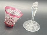 two glass vases sitting next to each other on a table