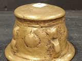 a small gold box sitting on a black surface