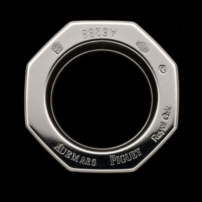 a close up of a silver coin with a black background
