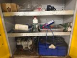 a yellow cabinet with a bunch of items in it