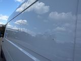 a white van that is parked on the side of the road