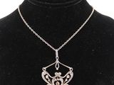 a necklace with a silver pendant on a black mannequin