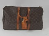 Sac Louis Vuitton avec des anses en cuir marron et des finitions beiges