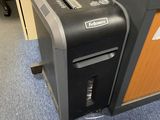 a black and gray paper shredder sitting on the floor