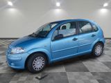 a picture of a small blue car parked in a garage