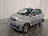 a picture of a small silver car parked in a garage