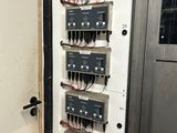 a wall mounted electrical panel in a room
