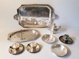 a silver tray and silver dishes on a white table