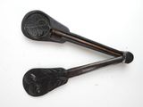 two spoons that are sitting on a white surface