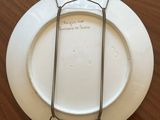 a white plate with a chain around it on a wooden table