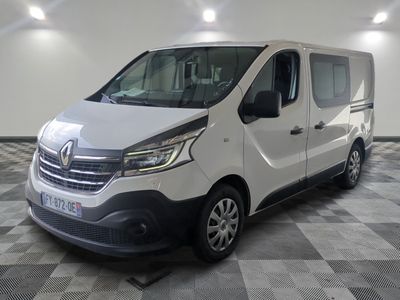 the white van is parked in a large room with a checkered floor