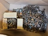 a box full of assorted metal screws and nuts