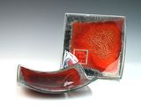 a glass bowl and a glass plate sitting on a table
