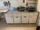 une cuisine équipée de placards blancs et d'une cuisinière