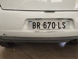 a white car that has a license plate on the back of it