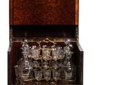 a wooden cabinet with many glasses in it