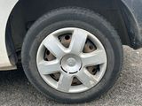 a white car with a flat tire on the street