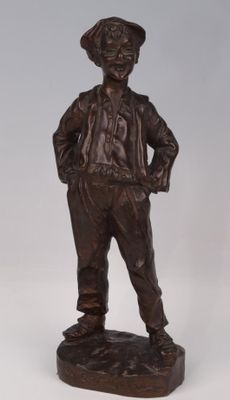 bronze statue of a boy with a hat and jacket standing on a base