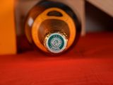 a bottle of beer that is sitting on a red table