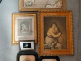 many framed pictures on the wall next to a clock