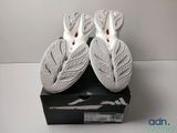 two white ceramic figurines of birds on top of a black box
