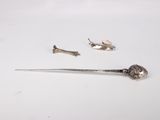 a silver spoon and a pair of scissors on a white table