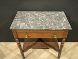 a small marble topped table with wooden legs and a drawer
