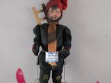 a toy figure of a skier with skis on a white surface