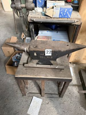 an old metal anvil on a table in a workshop
