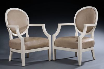 pair of white chairs with beige upholstered cushions on a black background