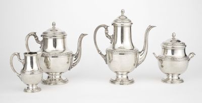 three pieces of silver tea and coffee set on a white background