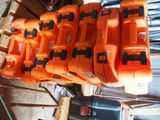 many orange and black tools sitting on top of each other