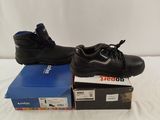 pair of black work boots on top of a blue box on a white surface