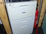 a white printer and a red fire hydrant in the corner of a room