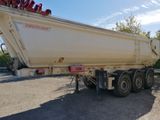 a large white dump truck parked on the side of the road